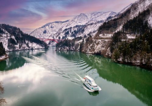 Shogawa River Valley in the mountains at Shirakawa. A cruise ship on the Shogawa. Toyama is located in Japan